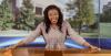 Marresa Burke posing at news desk at Middle Tennessee State University where she served as an anchor and reporter. 